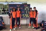 Northern Districts players stand in front of a scoreboard after setting a huge score.