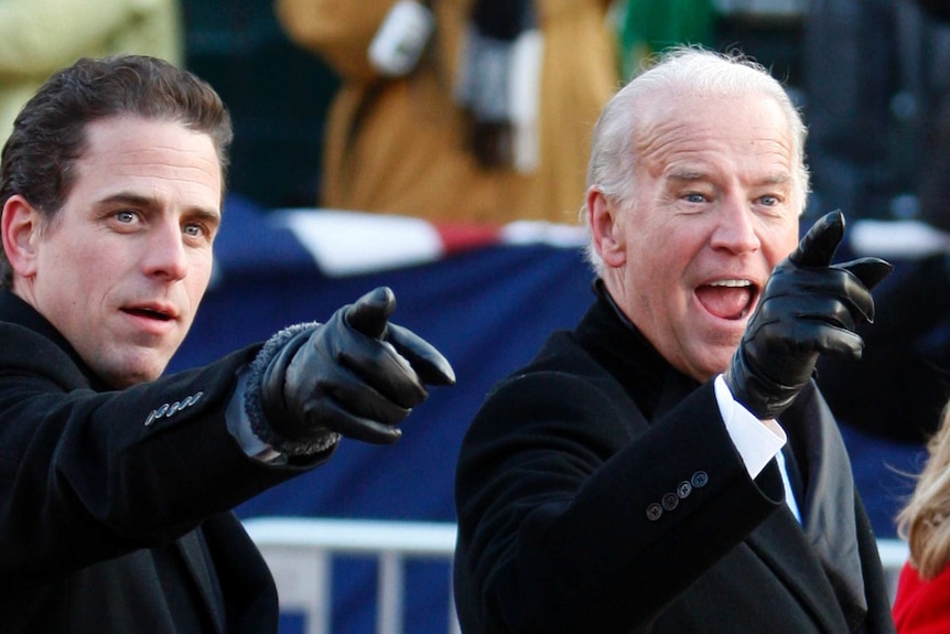 Vice President Joe Biden (R) points to some faces in the crowd with his son Hunter