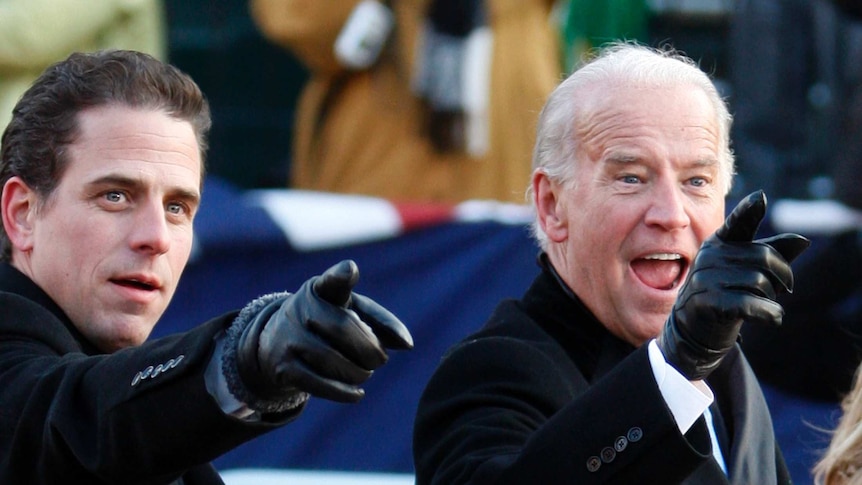 Vice President Joe Biden (R) points to some faces in the crowd with his son Hunter