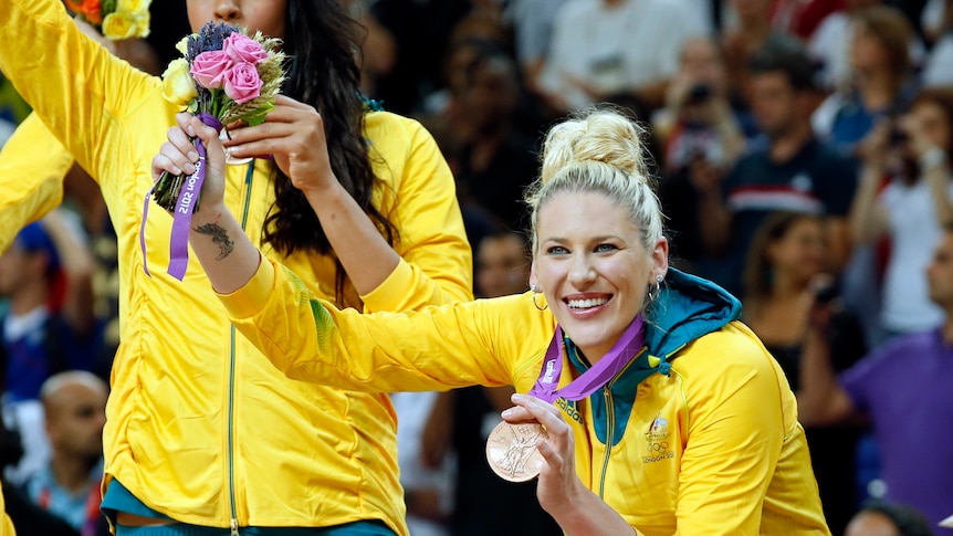Australian Opeals player Lauren Jackson holds her bronze Olympic medal and a bouquet of flowers at the 2012 London Games.