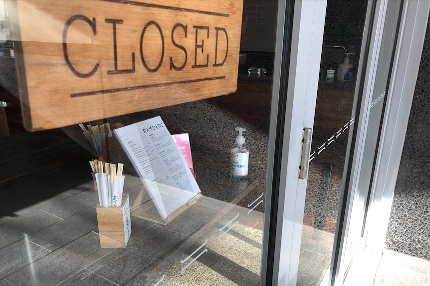A closed sign in a shopfront window.