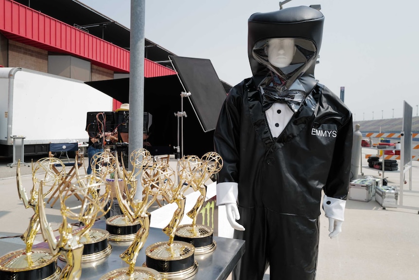 A hazmat suit that looks like a tuxedo and says Emmys on it.