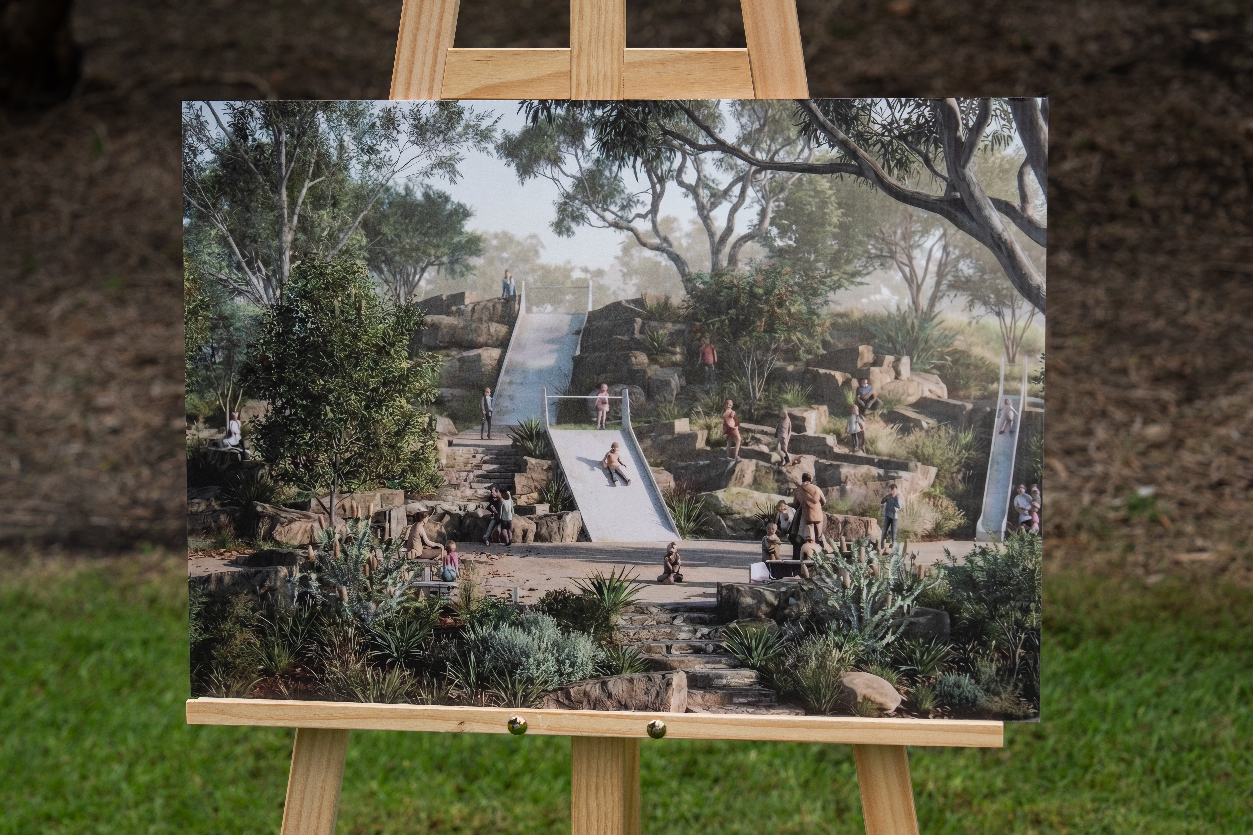 A future plan on an easel depicting a child's park in a golf course.
