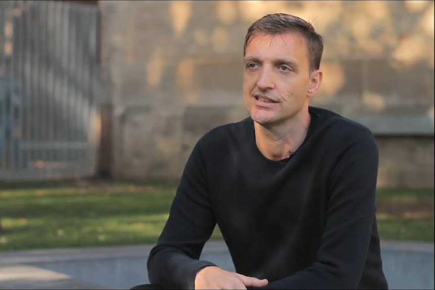 Jan Eeckhout in long-sleeved black T-shirt during an interview.