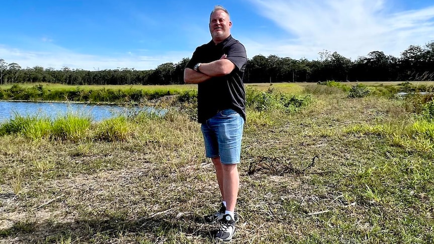 Man in black shirt standing at development site 