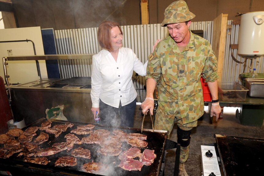 Prime Minister Julia Gillard shares a laugh with Sergeant Robin Core while visiting Tarin Kot.
