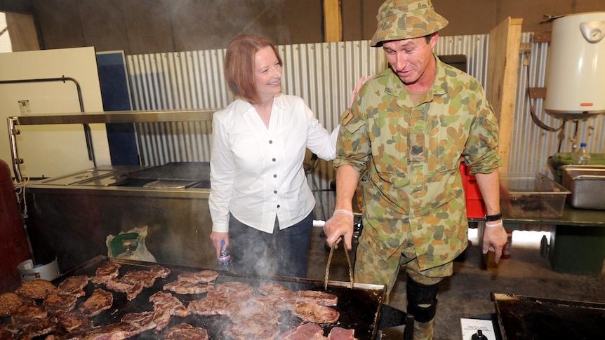 Prime Minister Julia Gillard shares a laugh with Sergeant Robin Core while visiting Tarin Kot.