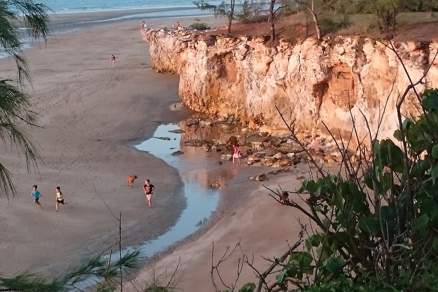 Children play near the base of the Dripstone Cliffs near Darwin.