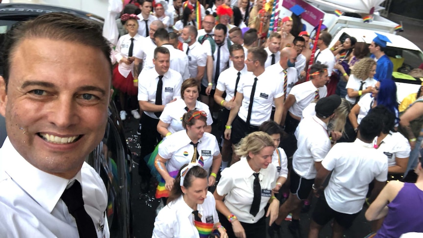 Brad Harker and dozens of others dressed as missionaries in the Peacock Mormons float at the 2018 Mardi Gras Parade.