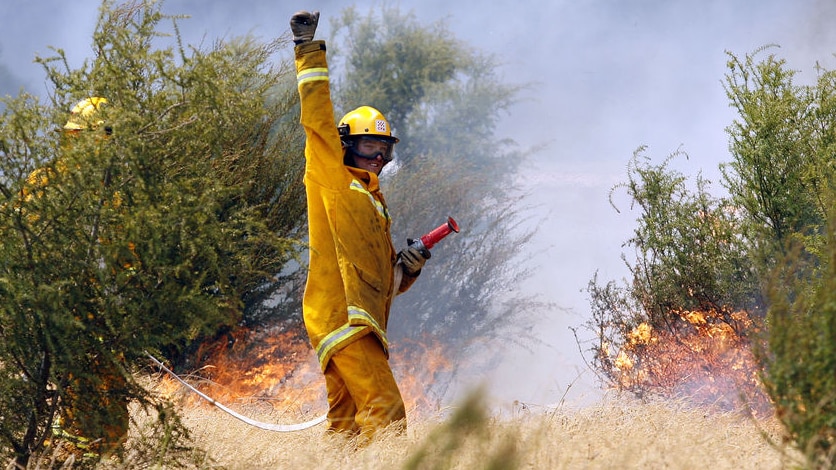 A firefighter signals to CFA colleagues in the Bunyip State Forest