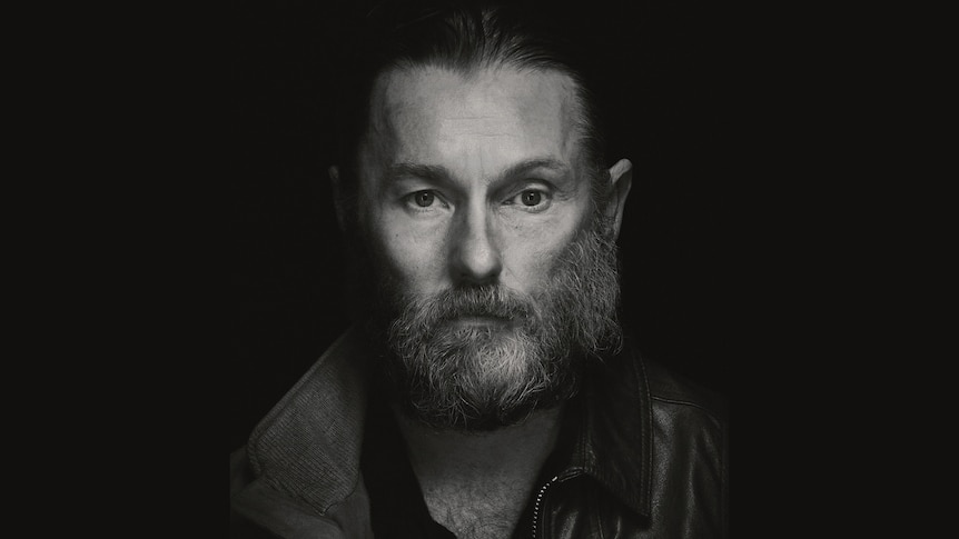 Half of Joel Edgerton's face merges into Sean Harris as their characters in The Stranger. 