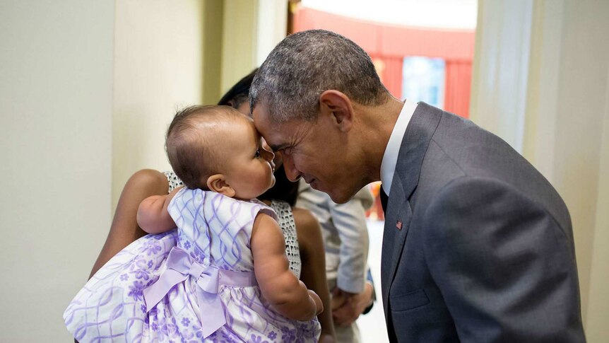 Barack Obama touches foreheads with nine-month-old Josephine Gronniger in the Oval Office.