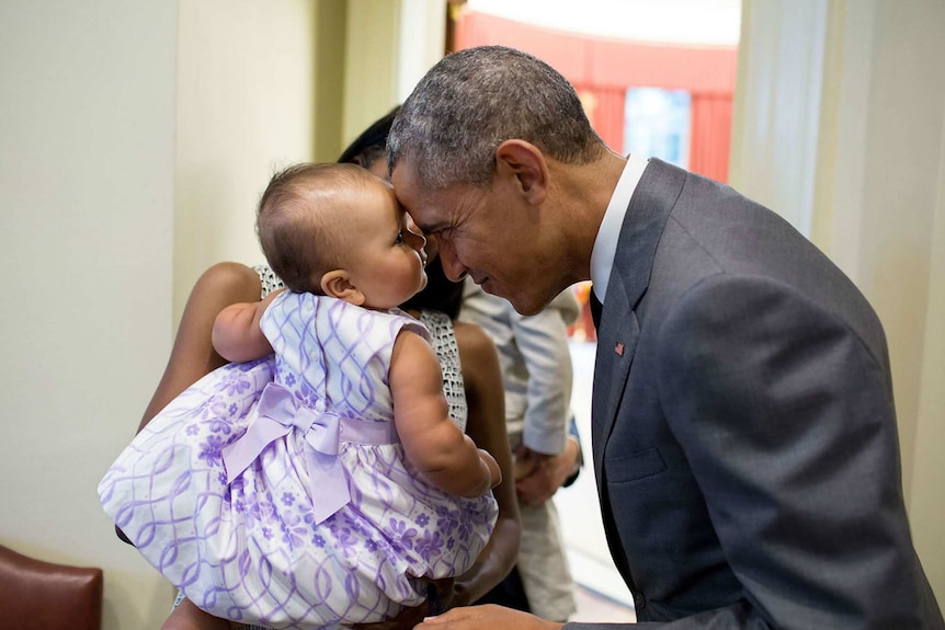 Barack Obama touches foreheads with nine-month-old Josephine Gronniger in the Oval Office.