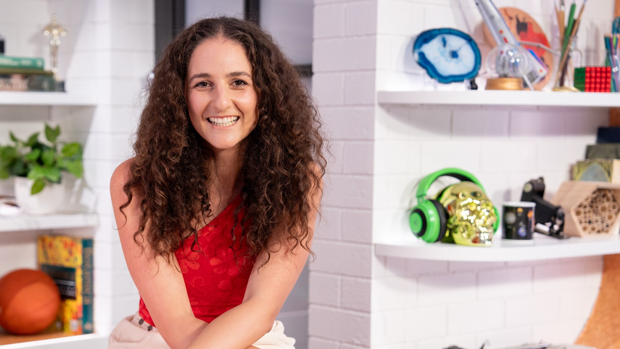 Michelle with her hands on her lap sits in the BTN studio smiling to camera. 