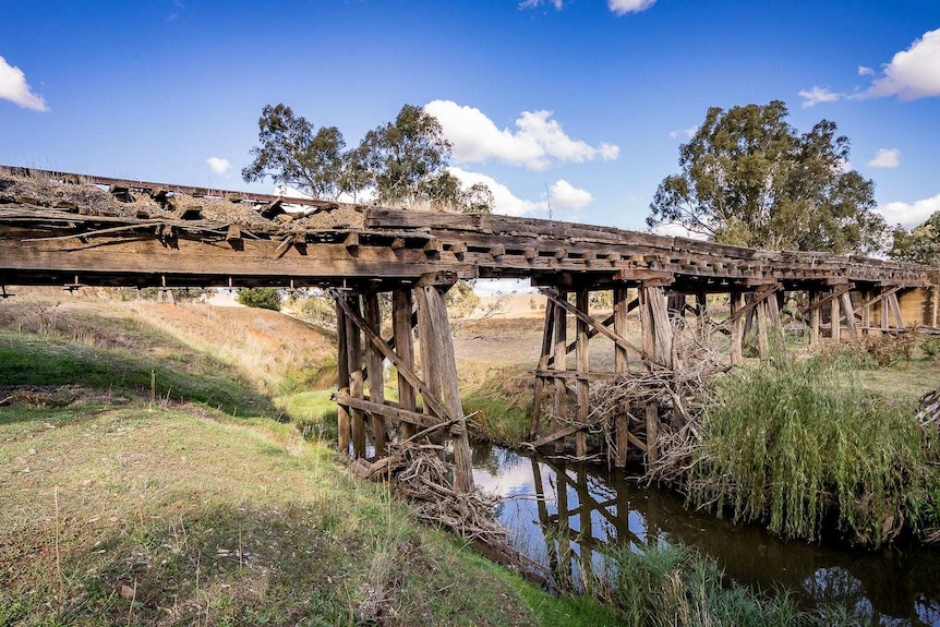 A wooden bridge crossing a small creek