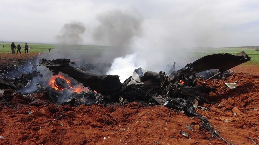 A general view shows the wreckage of a government warplane.