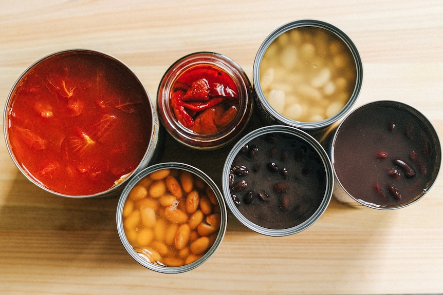 Open tins of tomatoes and beans, the ingredients of a vegetarian chilli, perfect for cold nights.