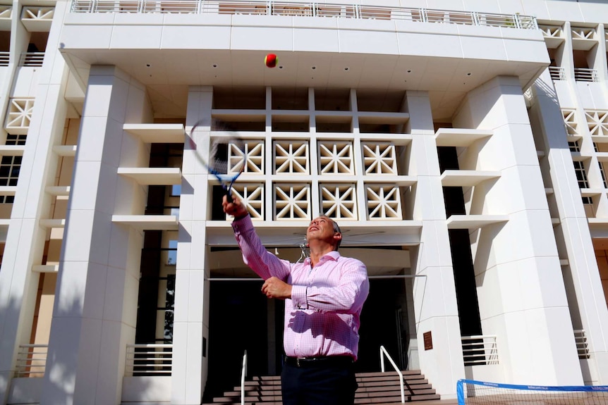 Chief Minister Adam Giles practises his tennis serve