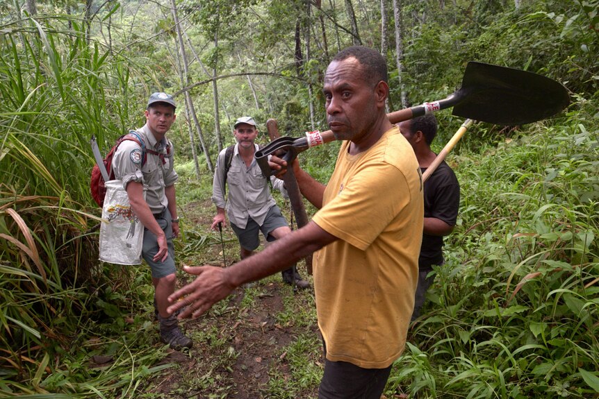 Local landowner Stanley Enage shows rangers Pat Kirby and Stuart Johnson a section of the Kokoda Track.