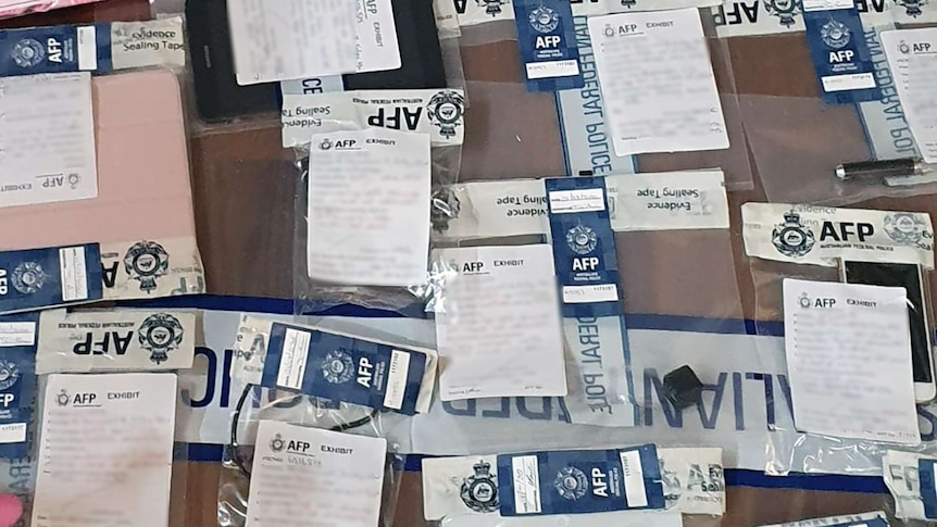 Evidence in police bags seized as part of investigation into the production of child abuse material