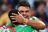 Two South Sydney Rabbitohs NRL players embrace as they celebrate a try.