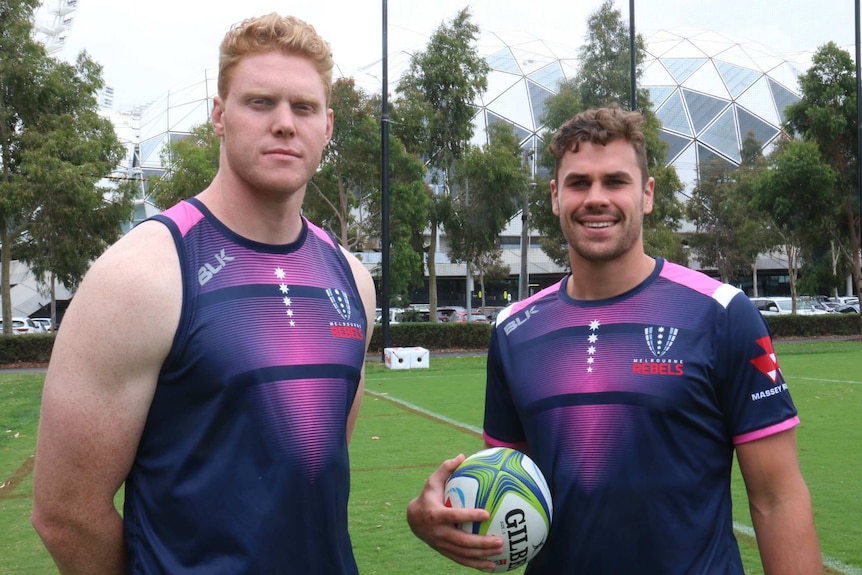 Sam Jeffries and Tom English looking straight at the camera in Melbourne Rebels training gear.