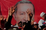 Supporters listen to a speech by Turkish President Tayyip Erdogan