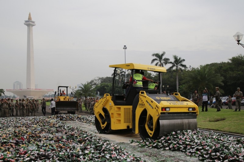 A steamroller crushes 20,000 bottles of alcohol in Jakarta.