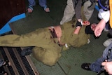 An Israeli soldier cowers as he is surrounded by activists on the Turkish aid ship, the Mavi Marmara