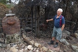 Joe Heaton looks out at the burnt out edge of his backyard