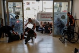Palestinians take cover during an Israeli raid in Jenin.