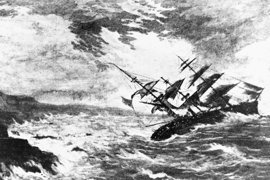 A black and white etching of an 1800s ship being wrecked on rocks during a storm.