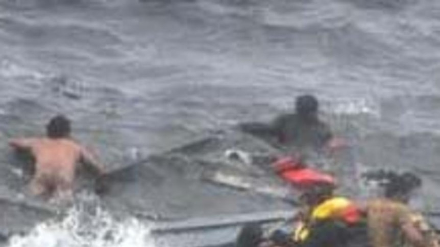 Asylum seekers cling to wreckage