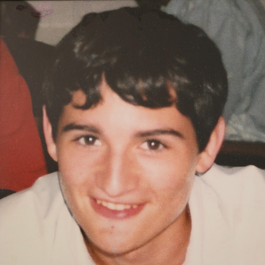 10 year old photo of a dark-haired boy, cropped close in on his face.