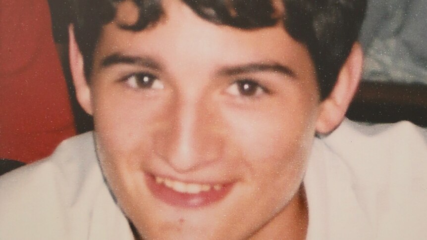 10 year old photo of a dark-haired boy, cropped close in on his face.