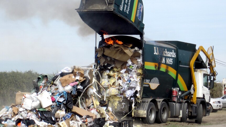 Fire breaks out in the back of a rubbish truck.
