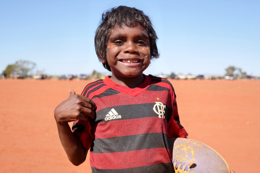 A child holding a football