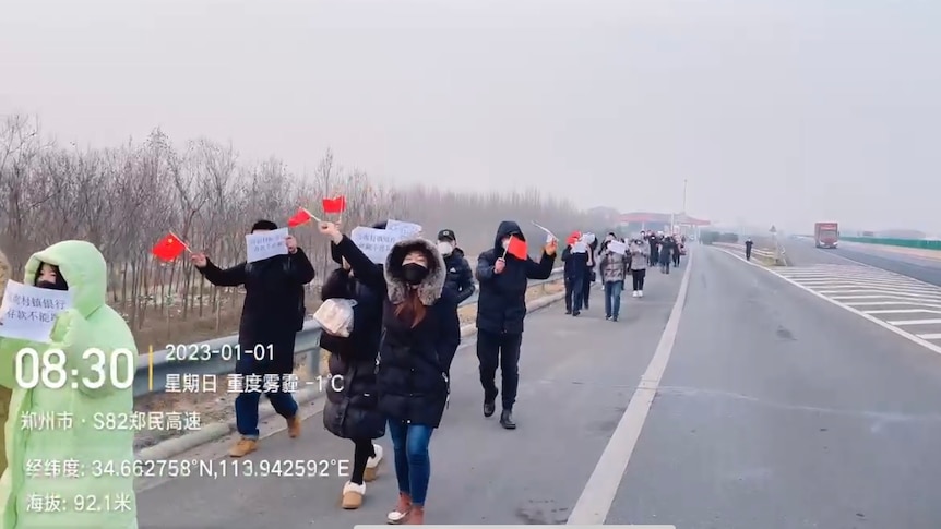 hundreds of people walked on the highway in a winter day
