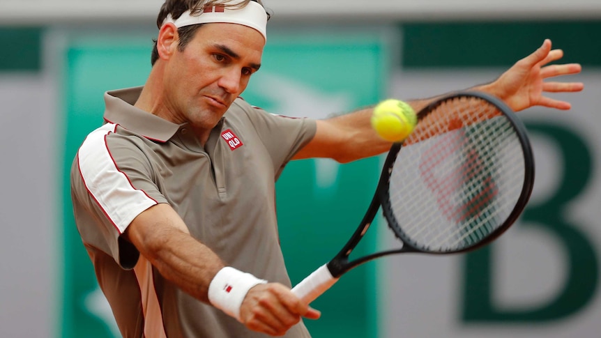 Roger Federer watches the ball onto the backhand of his racquet.