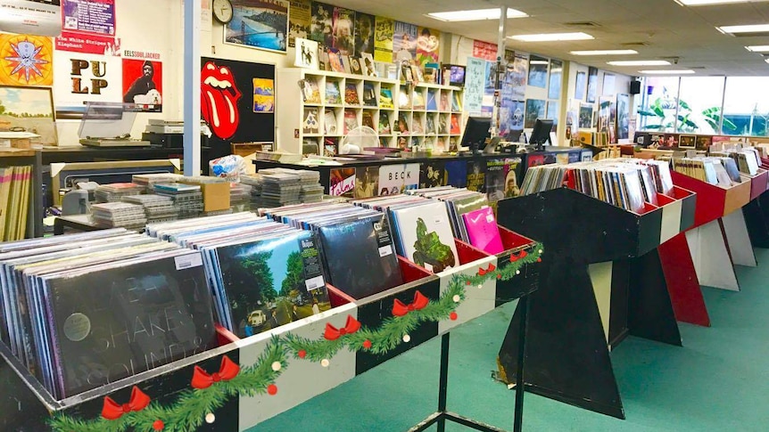 A music store showing racks of vinyl records.