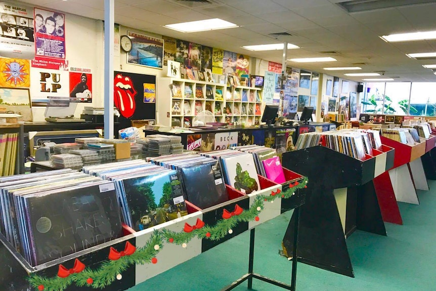 A music store showing racks of vinyl records.