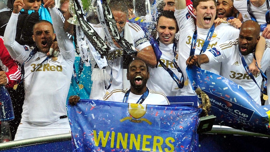 Swansea City players celebrate League Cup win.
