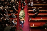 Pallbearers carry the casket of Ethel Lance