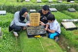 Andrian in the cemetery visit mum's grave