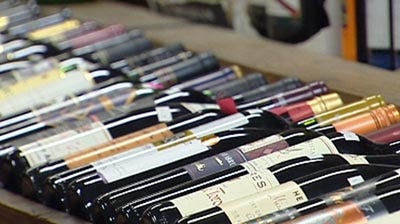 Wine bottles on a shelf in a bottle shop.