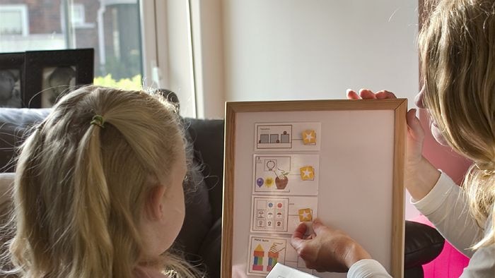 Preschooler and carer identifying working on activity.