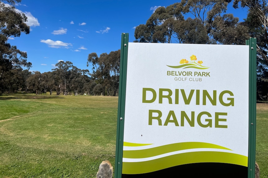 A sign saying 'Belvoir Park Golf Club driving range'.