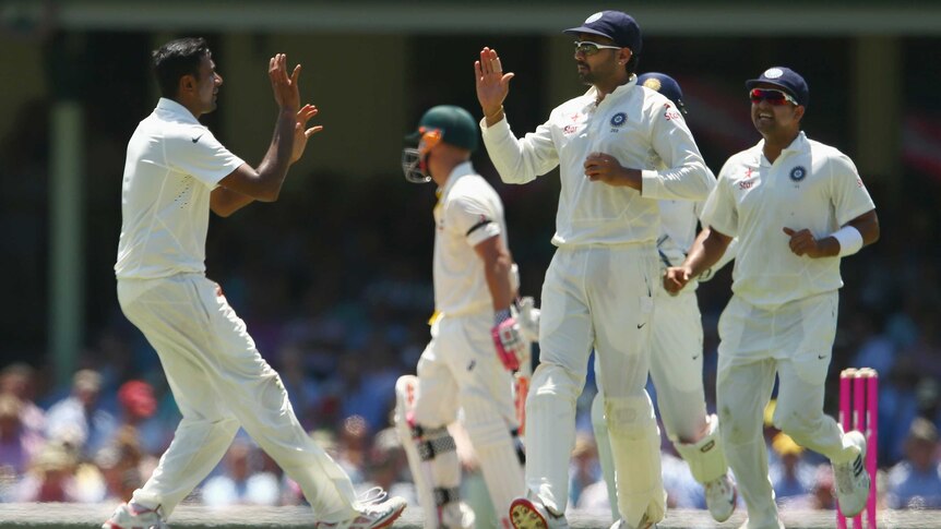 India's Ravichandran Ashwin and Murali Vijay after the wicket of Australia's David Warner at the SCG.