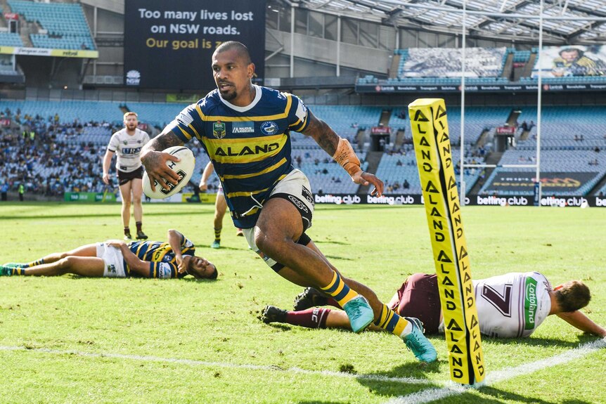 Manu Ma'u (C) scores for the Eels against the Sea Eagles at the Olympic stadium.