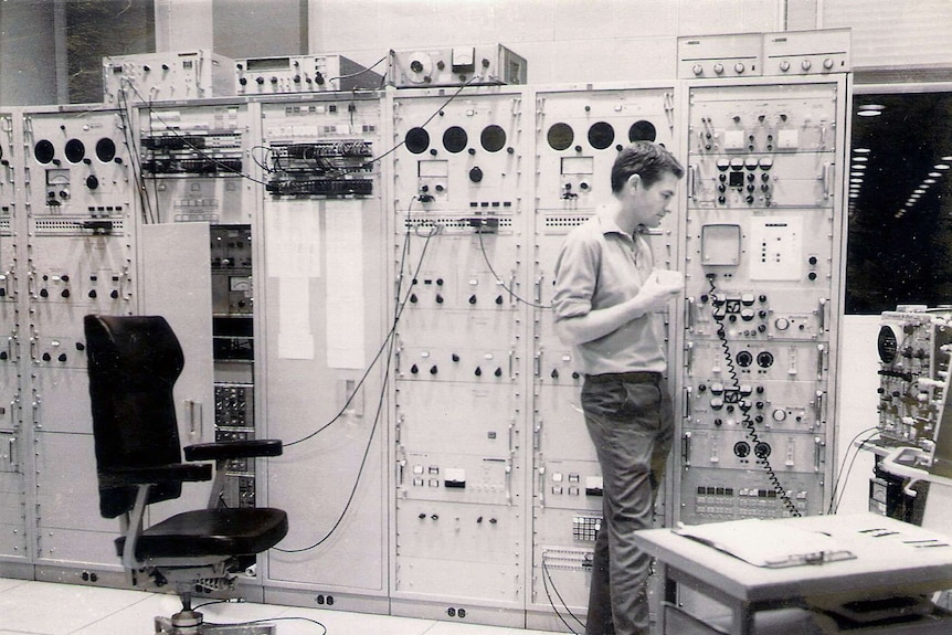 Mr Gallegos stands in front of computers.